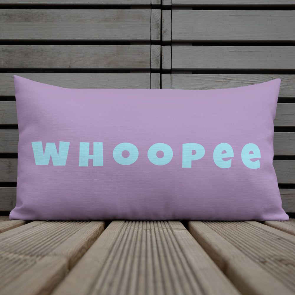 Vibrant, cheerful, and playful style accent pillow on wood deck with a fun Whoopee slogan in cyan letters on violet.