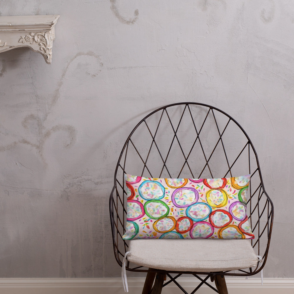 Vibrant, cheerful, and playful style accent pillow on modern chair with a multicolor graphic Frosted Cookies print on front.