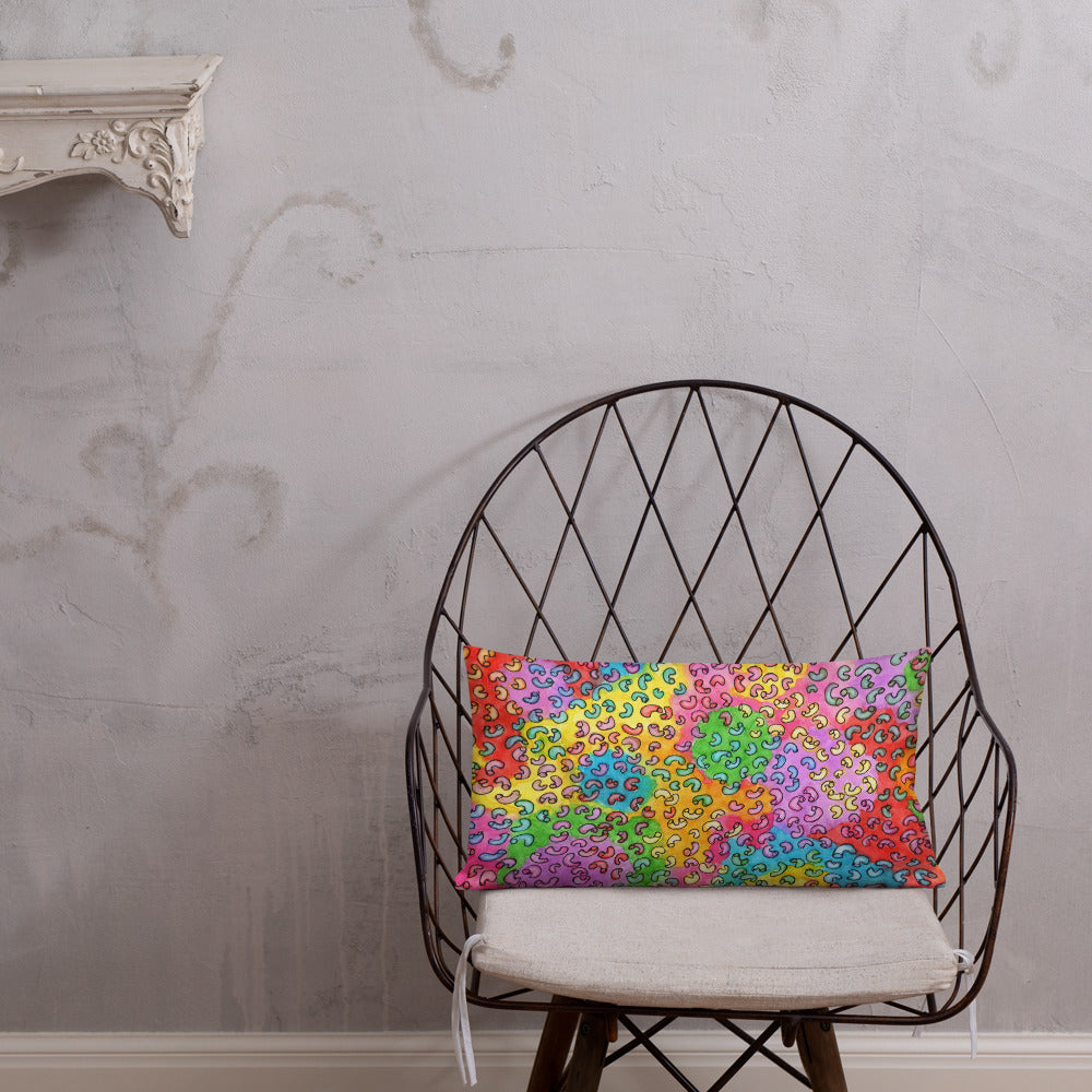 Vibrant, cheerful, and playful style accent pillow on modern chair with a multicolor graphic Macaroni print on front.