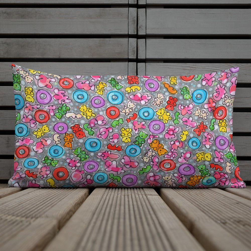 Vibrant, cheerful, and playful style accent pillow on wood deck with a multicolor graphic Popcornfroops print on front.