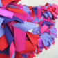 Detail of colorful and stylish soft lush fashion boa scarf in red, purple, pink colors limited edition Twinki-Winki view 1.